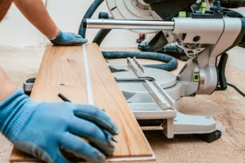 Preparing to cut wooden plank for flooring install